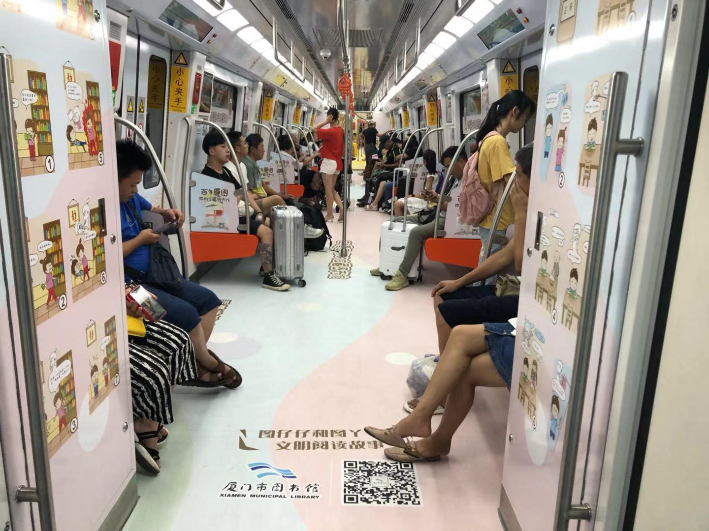 Wide subway carriage view with original comics installed on doors