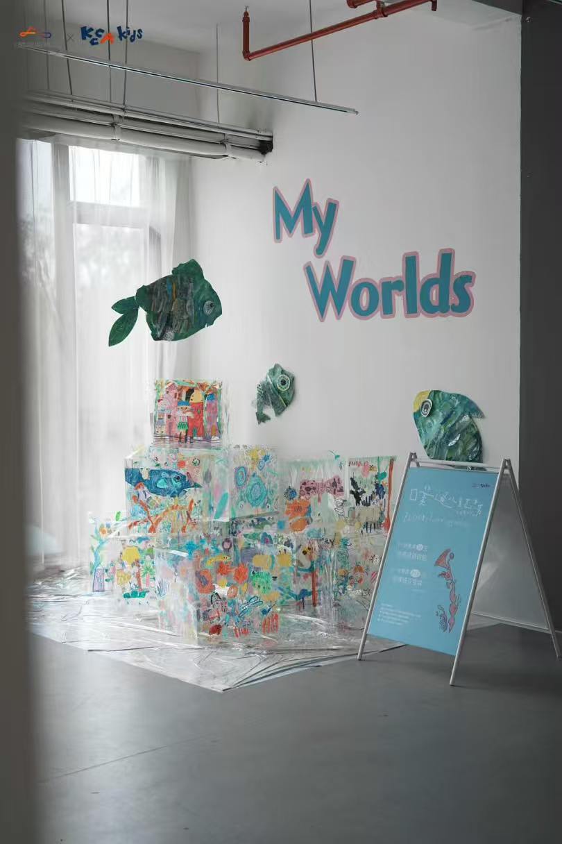 My Worlds installation with painted boxes and fish shapes