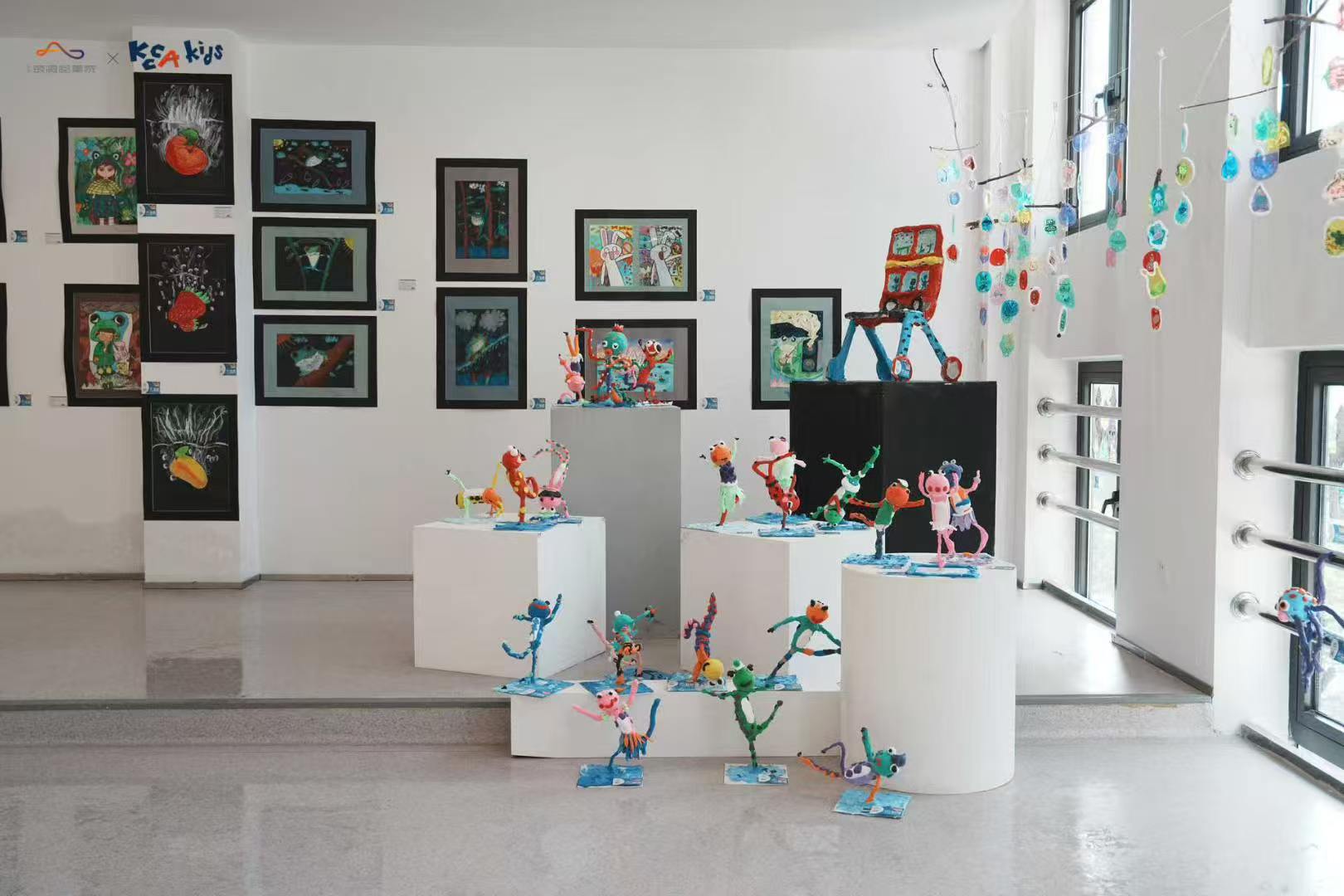 Exhibition room with sculptures and wall artworks