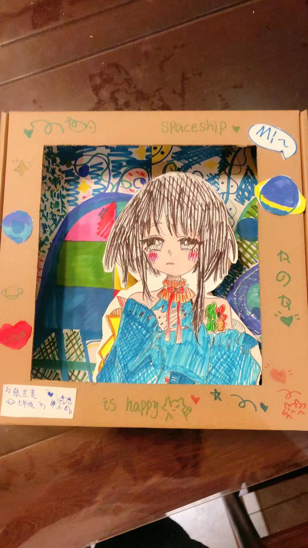 Anime inspired student artwork in a decorated box frame