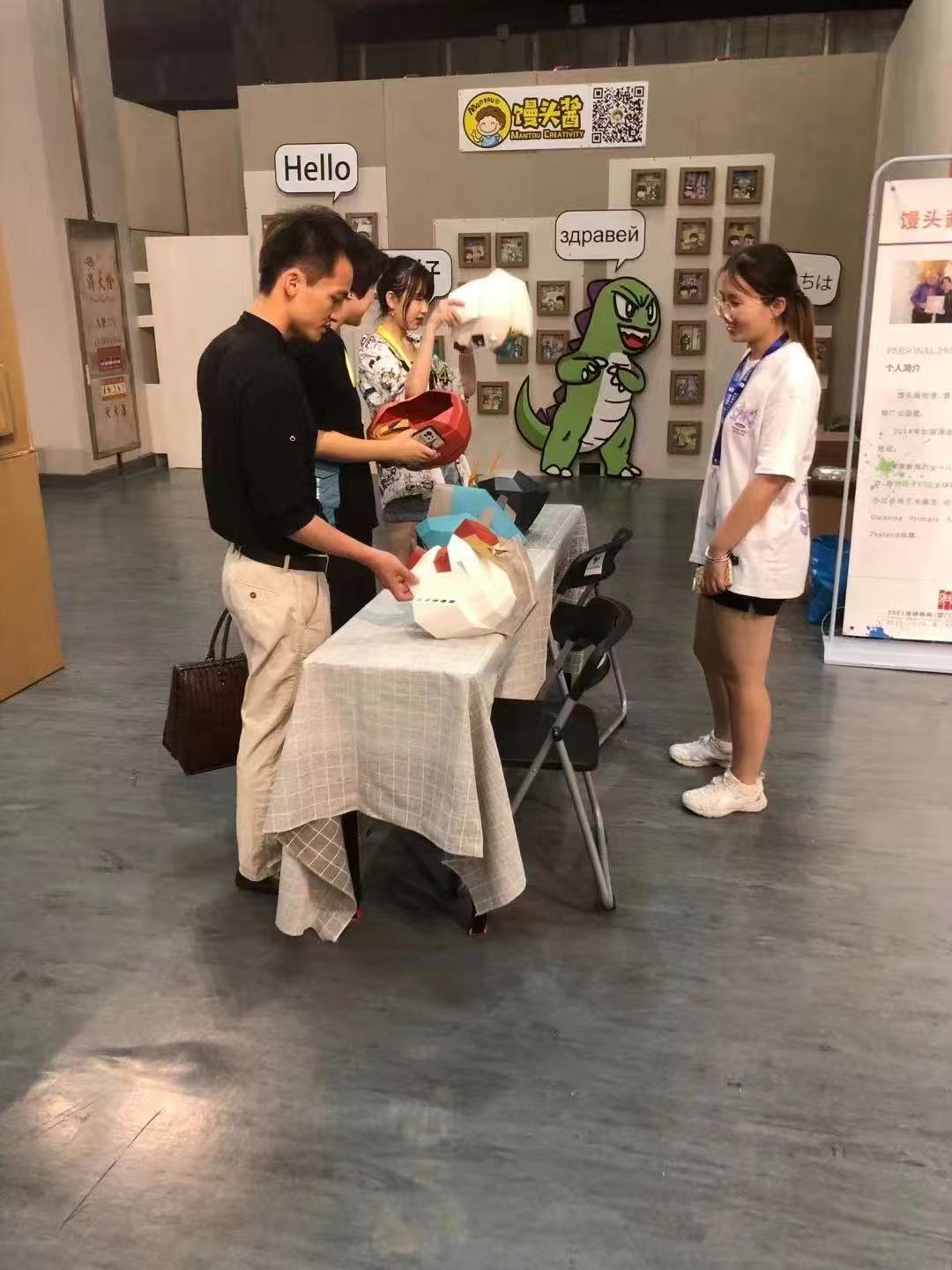Visitors at the A Thousand Faces Creative Exhibition activity table