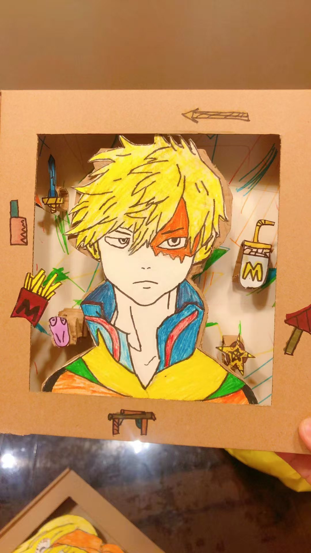 Student portrait artwork with yellow hair in a cardboard frame