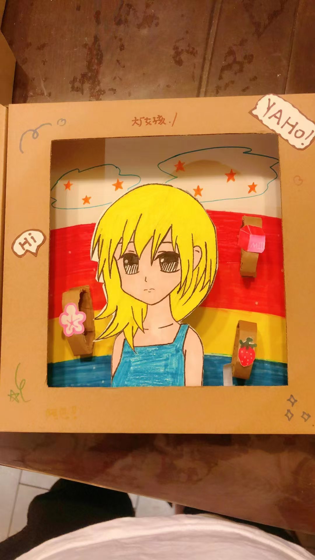 Student portrait artwork with a rainbow background in a cardboard frame
