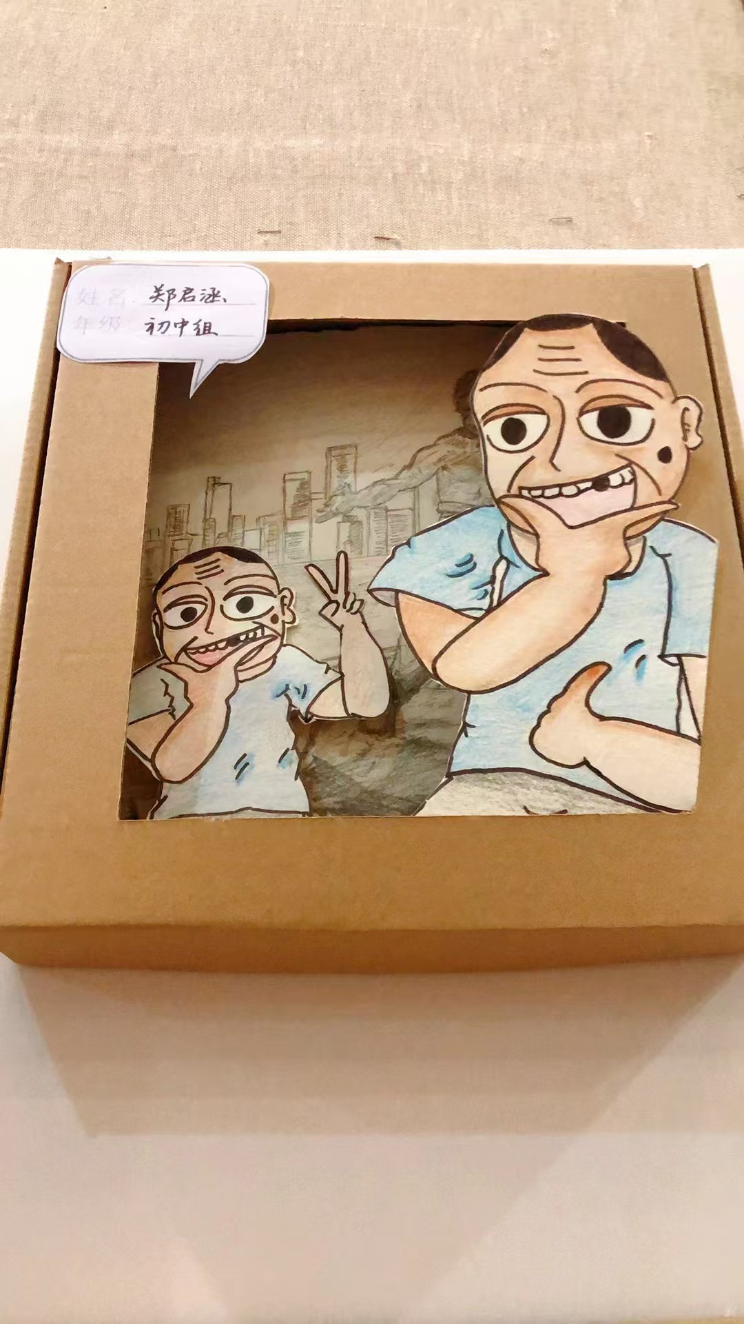Student portrait artwork with city background in a cardboard frame