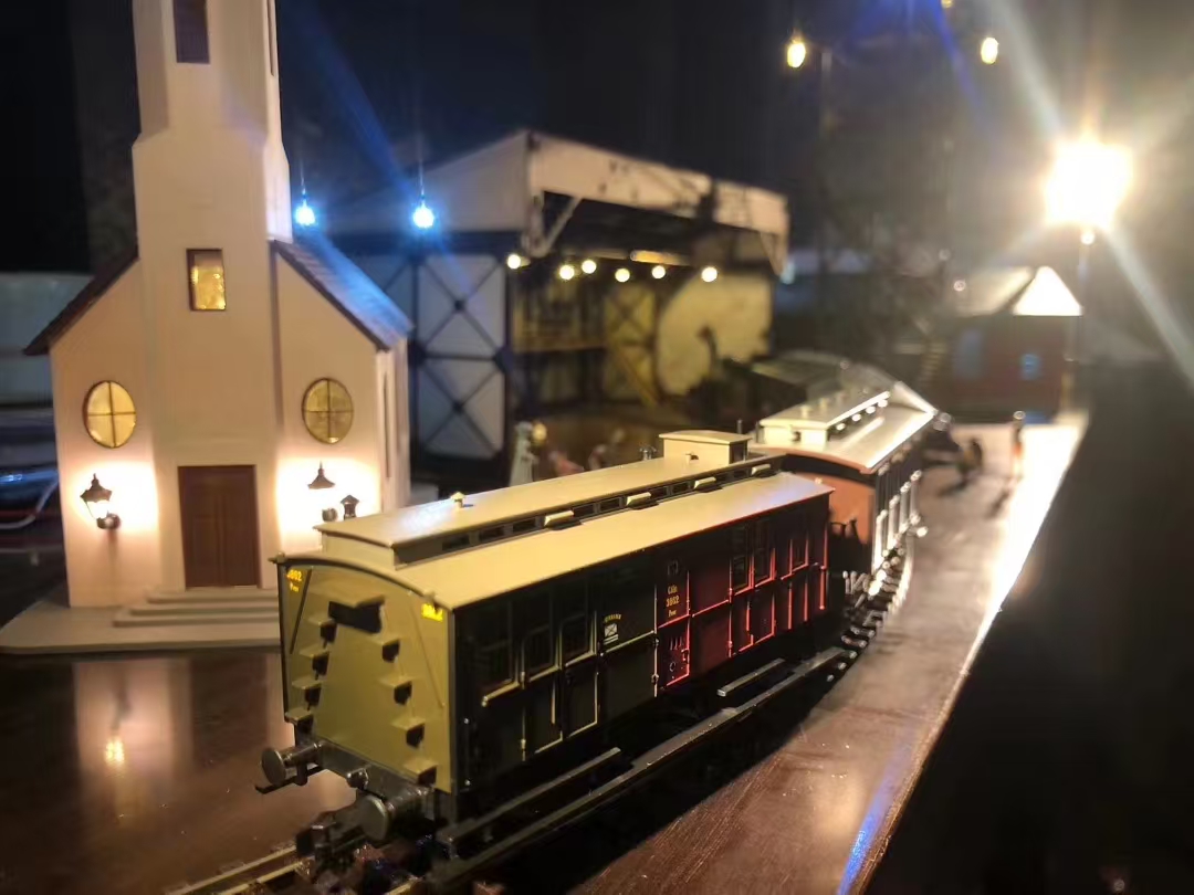Miniature night train scene with church and lights