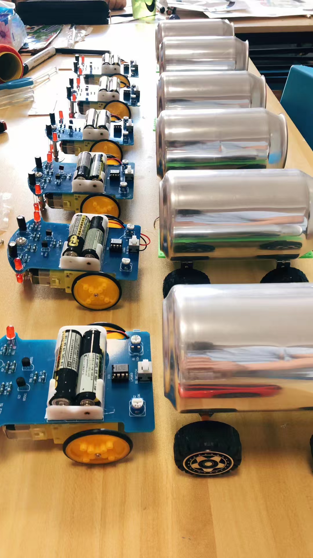 Rows of handmade rolling machine parts on a classroom table
