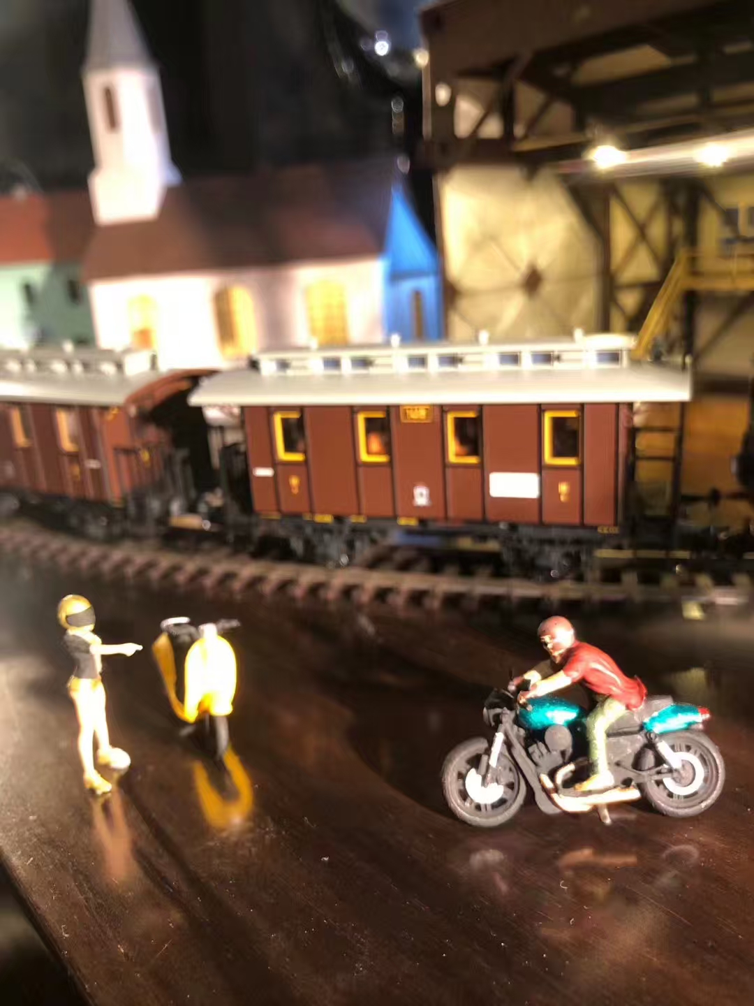 Miniature motorcycle scene in front of a train