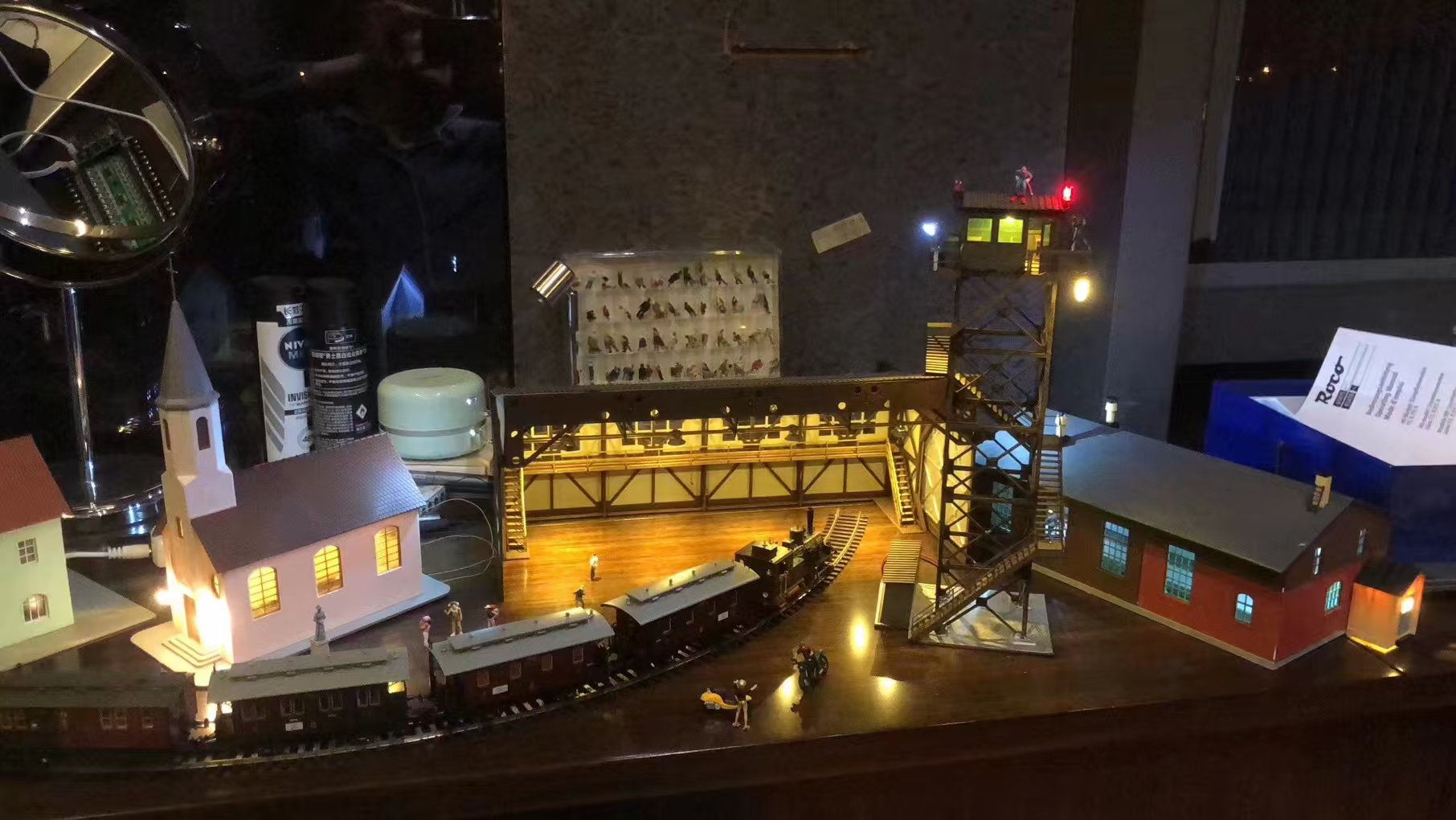 Illuminated handmade railway world with buildings and tower